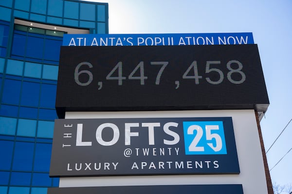 A sign at the Lofts at Twenty25 apartment complex counts the current population of Atlanta, as seen Wednesday. The ARC expects Fulton County alone to grow by 24% between 2020 and 2050. (Olivia Bowdoin for the AJC)