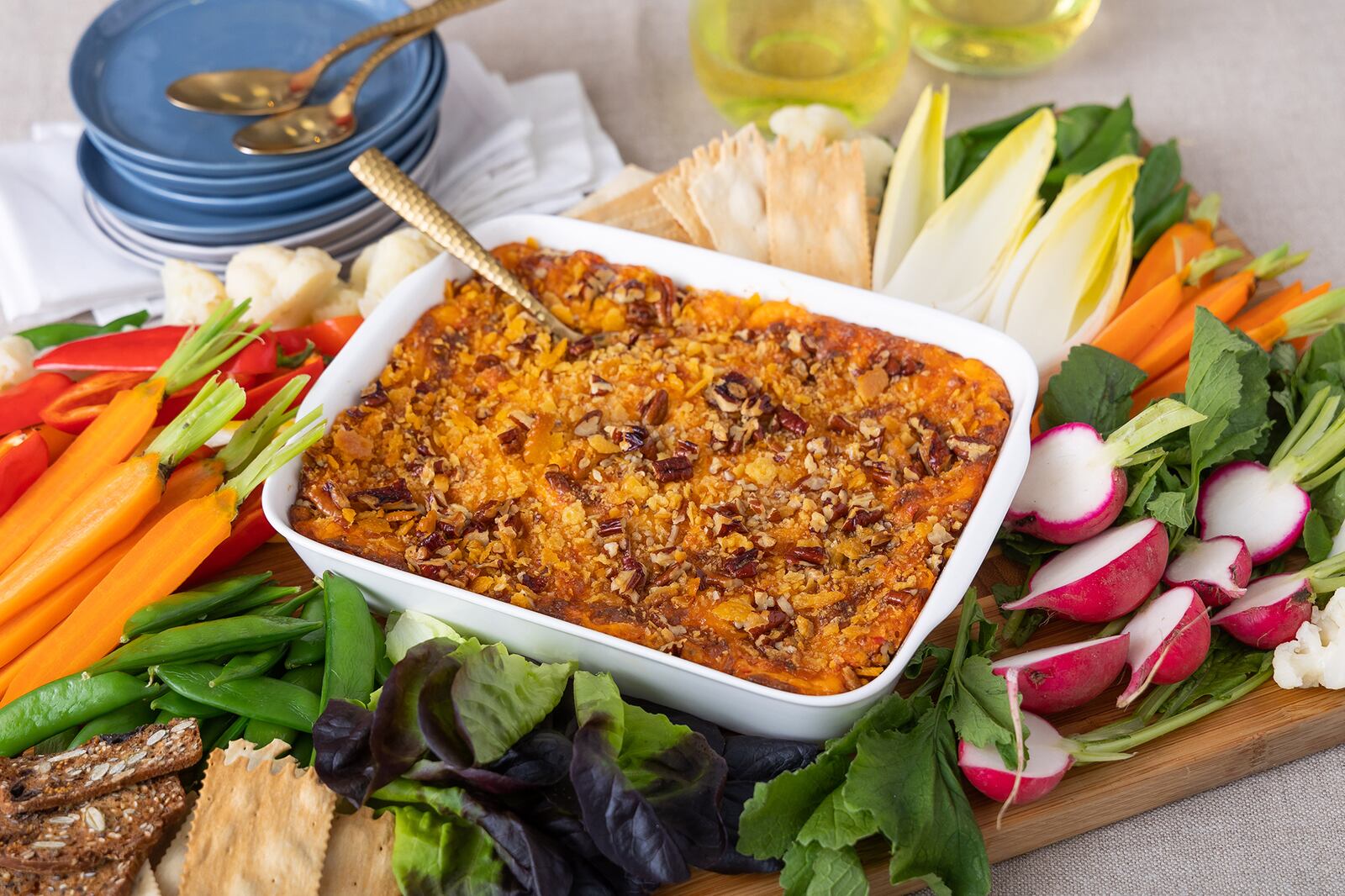 Everyone loves a cheesy, bubbly appetizer for the holidays. Elevate this Baked Pimento Cheese with a simple butter cracker-pecan crust and crudités made with vegetables quick-blanched for 1 minute to amplify their color. (Courtesy of Brooke Slezak)