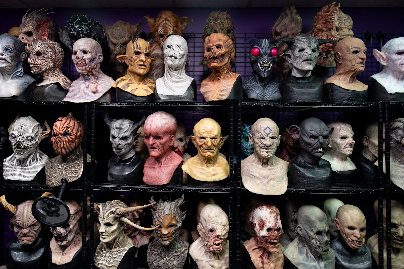 Full-face masks line the shelves at Netherworld haunted house in Stone Mountain on Friday, Oct. 25, 2024.   Ben Gray for the Atlanta Journal-Constitution