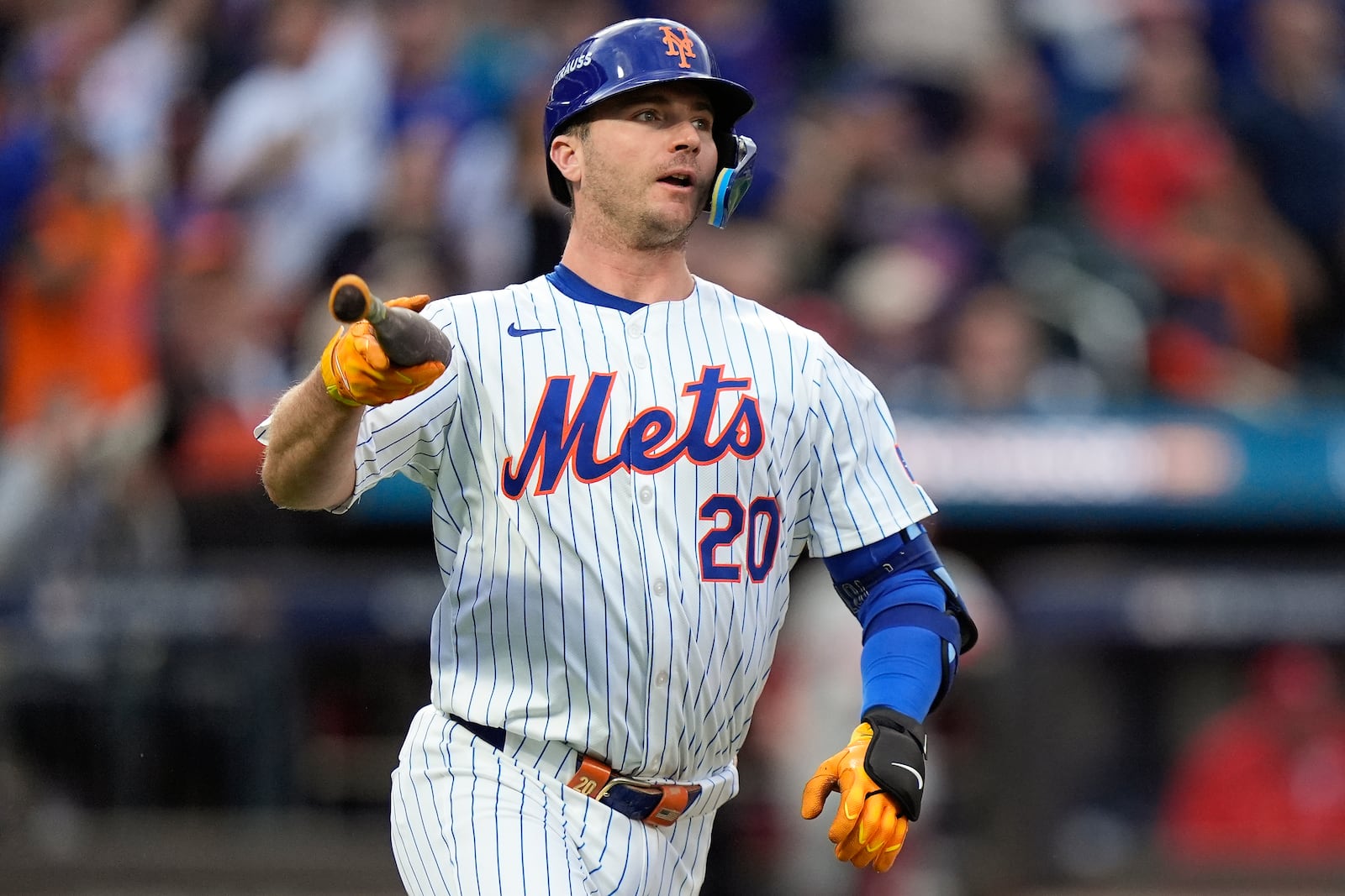 New York Mets' Pete Alonso (20) tosses his bat as he watches his solo home run sail over the right field wall against the Philadelphia Phillies during the second inning of Game 3 of the National League baseball playoff series, Tuesday, Oct. 8, 2024, in New York. (AP Photo/Frank Franklin II)