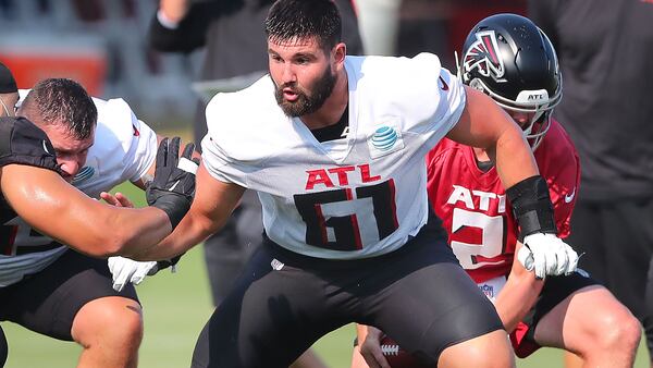 Falcons center Matt Hennessy blocks for Matt Ryan on a offensive play during the first day of training camp practice Thursday, July 29, 2021, in Flowery Branch.  (Curtis Compton / Curtis.Compton@ajc.com)