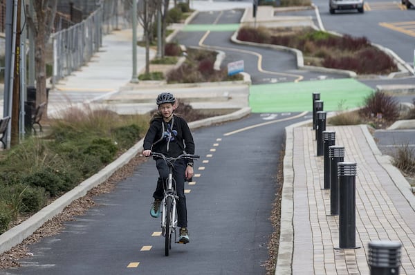 A bicyclist in the two-way bike lane along North McDonough Street in downtown Decatur, Thursday, January 23, 2020. (ALYSSA POINTER/ALYSSA.POINTER@AJC.COM)