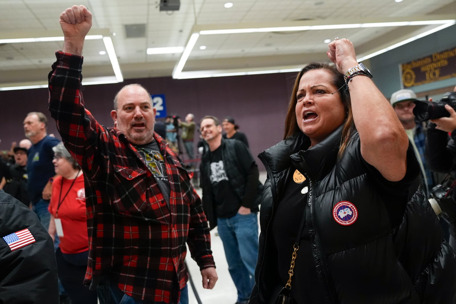 Boeing employees Harold Ruffalo, left, and Gina Forbush, right, react to the announcement that union members voted to reject a new contract offer from the company, Wednesday, Oct. 23, 2024, at Seattle Union Hall in Seattle. (AP Photo/Lindsey Wasson)