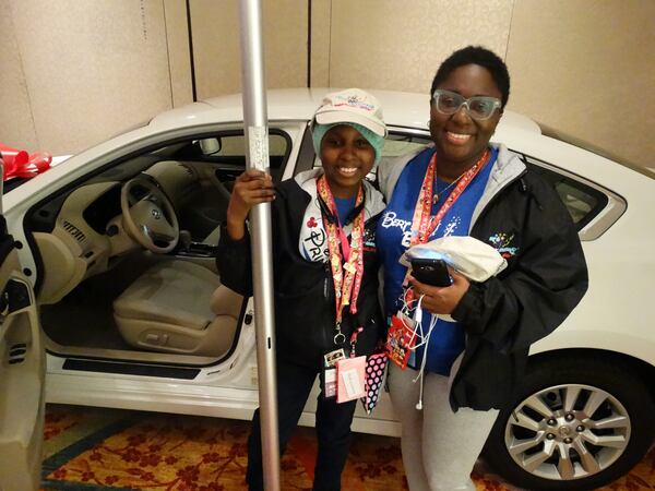 Ekuwa Ansah and her daughter Autumn with their brand new Audi. CREDIT: Rodney Ho/ rho@ajc.com