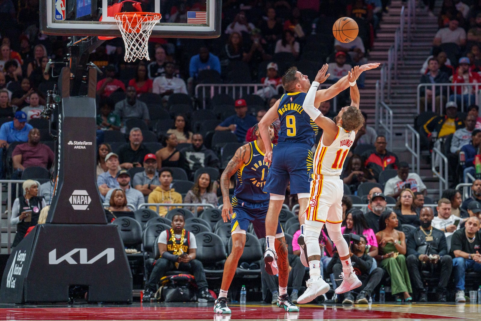 Indiana Pacers guard T.J. McConnell (9) blocks a shot by Atlanta Hawks guard Trae Young (11) during the first half of a preseason NBA basketball game, Tuesday, Oct. 8, 2024, in Atlanta. (AP Photo/Jason Allen)