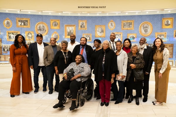 In 1912 nearly 1,000 black residents were expelled from Forsyth County. Pictured here are descendants of those expelled residents standing in front of an exhibit at Atlanta History Center that tells the stories of their relatives. In the center, wearing a black jacket, is Mattie Conley, daughter of Leola Strickland Evans.