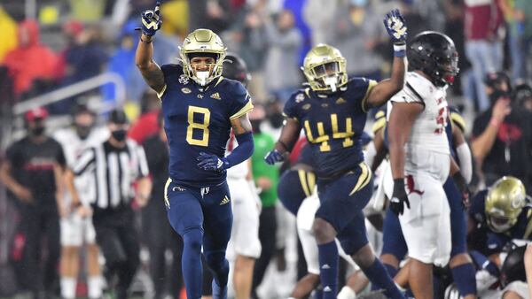 In this file photo, Georgia Tech's defensive back Tobias Oliver (8) and Georgia Tech's linebacker Quez Jackson (44) react after Georgia Tech's defensive lineman Jordan Domineck (not pictured) recovered a fumble during the second half of an Georgia Tech-Louisville game. (Hyosub Shin / Hyosub.Shin@ajc.com)