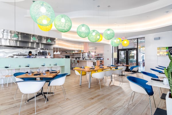 Pastel colors and bulbous paper lantern lights lend an inviting feel to Juniper Cafe's dining room. Courtesy of Eric Sun