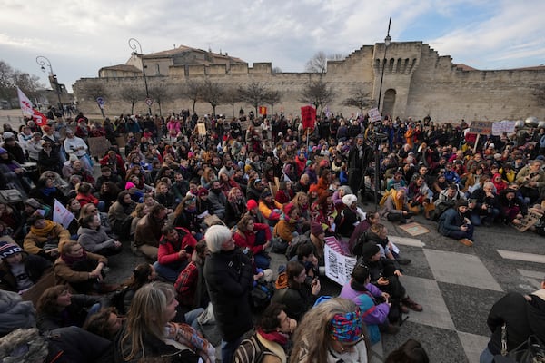 Activists gather during a women's rights demonstration, Saturday, Dec. 14, 2024 in Avignon, southern France, where the trial of dozens of men accused of raping Gisèle Pelicot while she was drugged and rendered unconscious by her husband is taking place. (AP Photo/Aurelien Morissard)