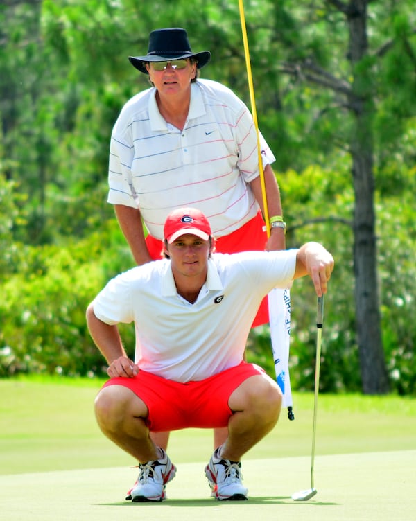 Georgia coach Chris Haack helps Sepp Straka read a putt Sunday at the NCAA championships at the Concession Golf Club in Bradenton, Fla. (Photo by Steven Colquitt)