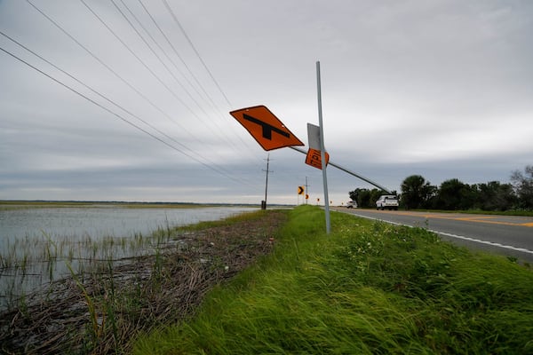 FILE: A sign for Fort Pulaski blows around as high winds batter the area on Thursday September 29, 2022 as Tybee Island felt the impact from Hurricane Ian. The National Park Service said that storms and sea-level rise are one of the causes for planned changes at the historic site.