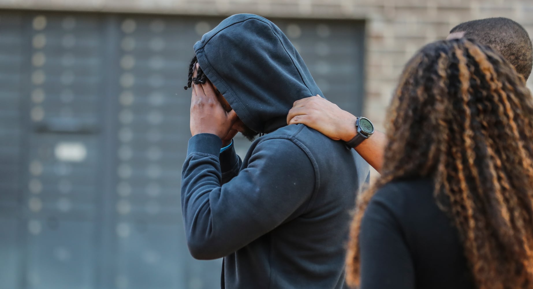 Family and friends of the victim take in the news after a fatal shooting at the One Riverside West complex located at 2030 Main Street in northwest Atlanta. 