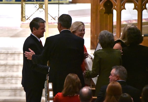 The Kemp family arrives at the Cathedral of St. Philip. AJC photo: Hyosub Shin