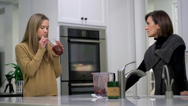 Nina Nichols, 18, takes her daily dose of Palforzia as her mother, Maria Acebal, watches.