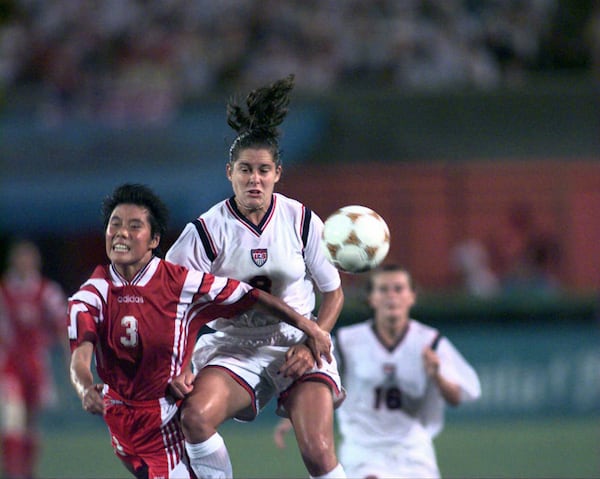 U.S. women's soccer team member Shannon MacMillan (8) and China's Yunjie Fan (3) battle for control of the ball in first half of the gold medal women's soccer game Thursday, Aug. 1, 1996, at Sanford Stadium in Athens. MacMillan scored a goal on the drive. The U.S. won 2-1. (David Tulis/AJC)