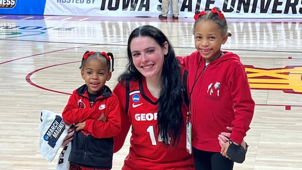 Georgia's Jenna Staiti with the children of head coach Joni Taylor, Drew (left) and Jacie (right) following the Lady Bulldogs NCAA Tournament game against Iowa State. It was Staiti's final game of her career at Georgia.