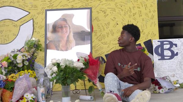 Apalachee High School student Isaac Sanguma stares at a picture of Cristina Irimie, a teacher at his school who was killed in a shooting at the school on Sept. 4. Sanguma wrote a rap song in her memory that has drawn several million likes on social media. (April Lanuza/AJC)