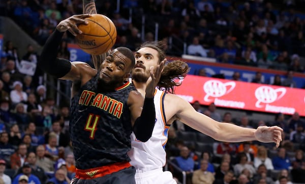 Atlanta Hawks forward Paul Millsap (4) grabs a rebound in front of Oklahoma City Thunder center Steven Adams, right, in the first half of an NBA basketball game in Oklahoma City, Monday, Dec. 19, 2016. (AP Photo/Sue Ogrocki)