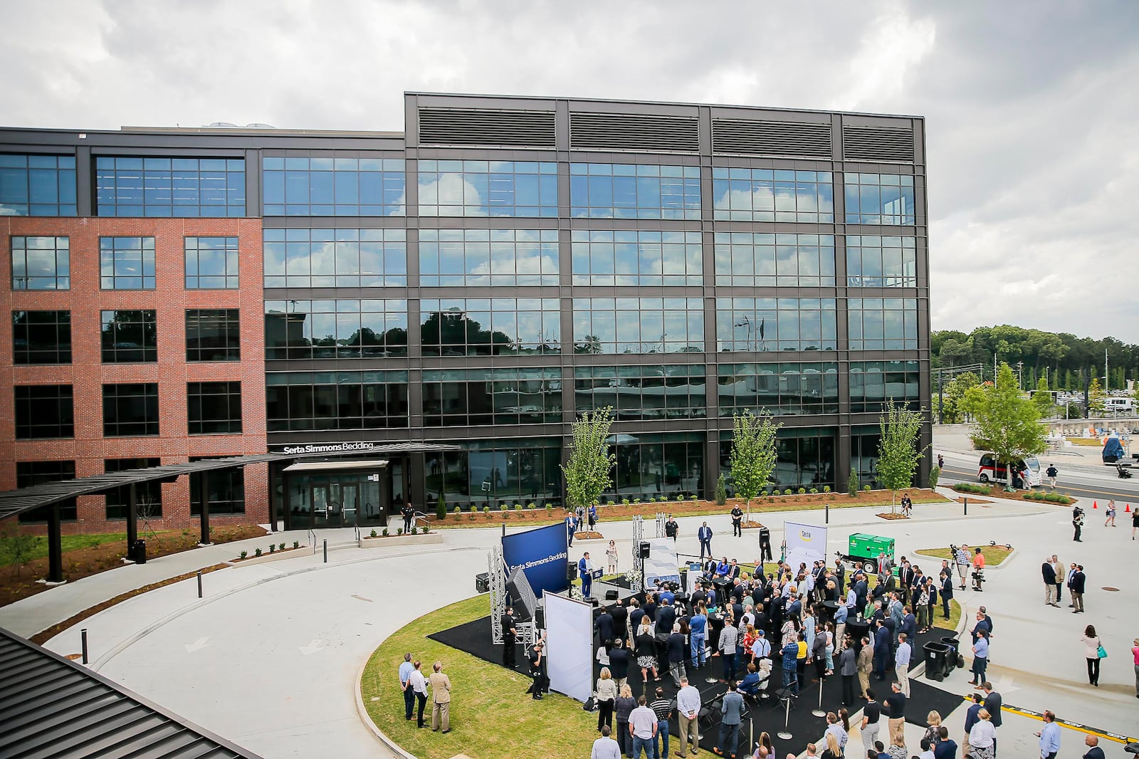 People gather outside of Serta Simmons Bedding's new national headquarters during a grand opening celebration at Assembly in Doraville in May.