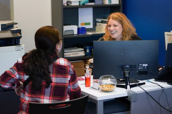 Eva Lynch speaks to a job seeker during a job fair at her work on Wednesday, November 10, 2021, in Marietta. Lynch quit her job at a clothing store in April before taking a new job at a staffing firm as a recruiter. (Elijah Nouvelage for The Atlanta Journal-Constitution)

