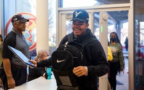 A student grabs their laptop after walking through security at Maynard Jackson High School in Atlanta on Tuesday, January 10, 2023. Atlanta Public Schools implemented new Evolv Technology weapons detection systems in middle and high schools. CHRISTINA MATACOTTA FOR THE ATLANTA JOURNAL-CONSTITUTION.