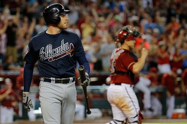 Arizona Diamondbacks' Miguel Monterom right, walks to the mound to celebrate their win as Atlanta Braves' Freddie Freeman walks to the dugout after striking out to end the baseball game, Sunday, June 8, 2014, in Phoenix. The Diamondbacks won 6-5. (AP Photo/Matt York) Snake-bitten: Freddie Freeman strikes out to end Sunday's game. (Matt York/AP)