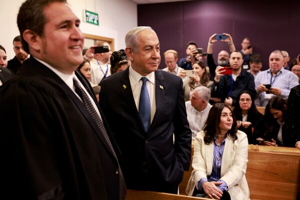 Israeli Prime Minister Benjamin Netanyahu, center, arrives at the district court for his long-running trial for alleged corruption, in Tel Aviv, Israel, Tuesday, Dec. 10, 2024. (Menahem Kahana/Pool Photo via AP)