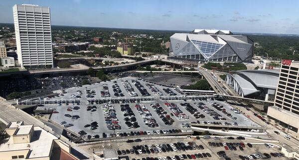 California-based developer CIM Group wants to build a 40-acre mixed-use project on top of the railroad lines and parking lots between Mercedes-Benz Stadium, right, and the Five Points MARTA station, to the left of this image. CIM plans to rebrand the Gulch as Centennial Yards to reflect the site’s proximity to Centennial Olympic Park and its history as a crucial rail junction in downtown. J. Scott Trubey/strubey@ajc.com