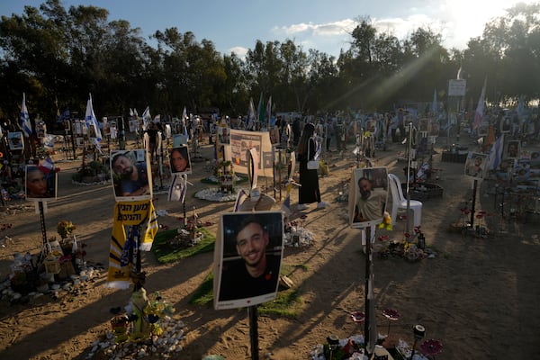 FILE - People visit the site of the Nova music festival, where hundreds of revelers were killed and abducted by Hamas and taken into Gaza, on the one-year anniversary of the attack near Kibbutz Reim, southern Israel, on Oct. 7, 2024. (AP Photo/Ariel Schalit, File)