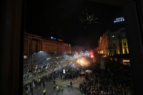 People welcome protesters from provinces who have arrived ahead of a major rally this weekend in downtown Belgrade, Serbia, Friday, March 14, 2025. (AP Photo/Darko Vojinovic)