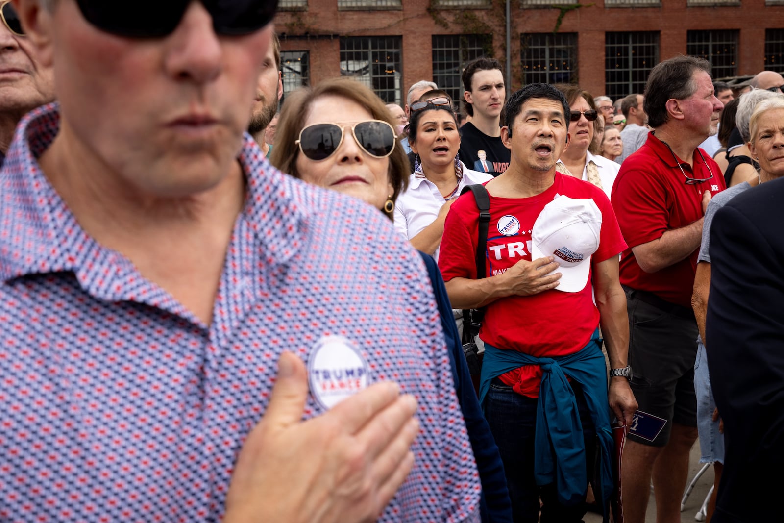 Fun Fong held his hat over his heart during the national anthem at Republican vice presidential candidate JD Vance’s rally in Lindale on Friday, Oct. 4, 2024. Fong, a Smyrna resident who ran unsuccessfully for state House in 2022, said it makes sense for campaigns on both sides of the aisle to court Asian American voters. "Asians have typically been wanting to stay out of the limelight. They don’t want to stick out. They’re probably afraid of expressing themselves a lot of time," he said. "So basically, both parties are recognizing that this demographic is an untapped resource that under votes. And I think that’s part of the attempt to promote partisan candidates."