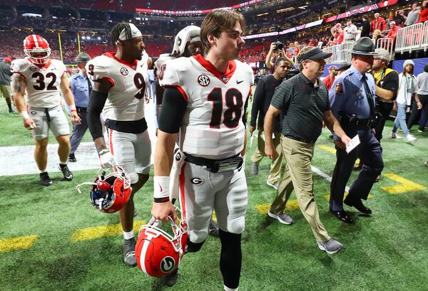 Georgia quarterback JT Daniels and head coach Kirby Smart walk off the field after the 41-24 loss to Alabama in the SEC championship game.