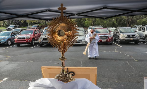 Deacon Fred Johns presided over "Drive-In" Adoration of the Most Blessed Sacrament in this March 25, 2020 file photo where some 50-cars attended in the parking lot at St. Pius X Catholic Church in Conyers. Normally Adoration occurs in small chapels outside the main sanctuary when Mass is not being celebrated. Since the COVID-19 outbreak, Catholics in the Atlanta Archdiocese and around the world have been implementing creative ways to serve the faithful. JOHN SPINK/JSPINK@AJC.COM