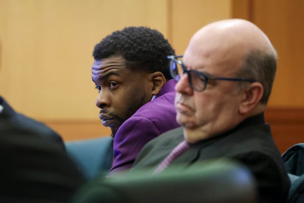 Defendant Deamonte Kendrick, center, sits next to his defense attorneys Doug Weinstein at the courtroom of Judge Ural Glanville at the Fulton County Courthouse, Friday, March 22, 2024, in Atlanta. (Jason Getz / jason.getz@ajc.com)