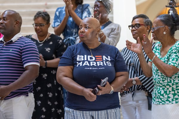 Leah Foster (center), a member of Flipper Temple AME church, stands in support at a press conference for Black clergy showing solidarity for Joe Biden at the Capitol in Atlanta on Thursday, July 11, 2024. (Arvin Temkar / AJC)