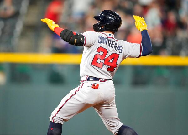 Atlanta Braves' William Contreras celebrates after reaching second base with an RBI double off Colorado Rockies relief pitcher Jhoulys Chacin during the 11th inning of a baseball game Saturday, June 4, 2022, in Denver. (AP Photo/David Zalubowski)