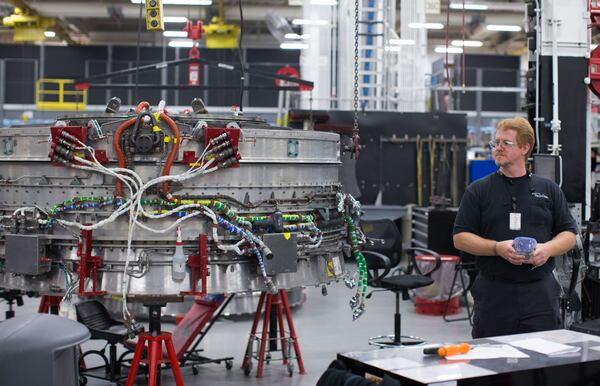 A Delta TechOps employee stands beside part of an airplane engine inside a Delta TechOps building near Hartsfield-Jackson Atlanta International Airport, Monday, Oct. 26, 2015, in Atlanta. Delta announced a new partnership with Rolls Royce as an approved maintenance center. BRANDEN CAMP/SPECIAL