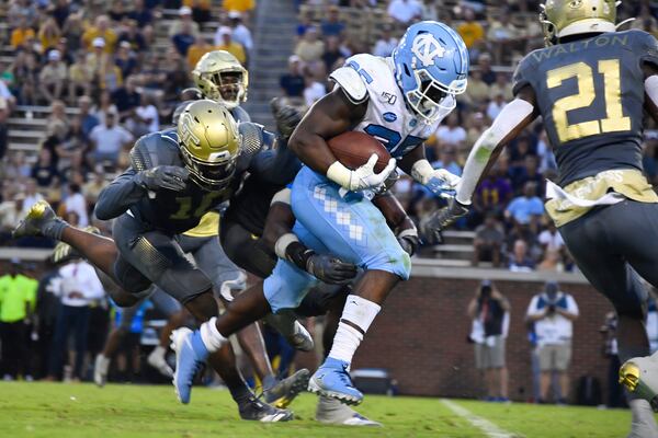 North Carolina running back Javonte Williams barrels through the Georgia Tech secondary for yardage during the second half Saturday, Oct. 5, 2019, in Atlanta. North Carolina won 38-22. (John Amis/For the AJC)