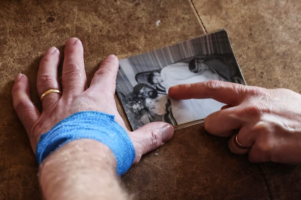 Jake Heinrichs holds a photo of his father who died from Alzheimer's, in New York, on Wednesday, March 12, 2025. (AP Photo/Heather Khalifa)