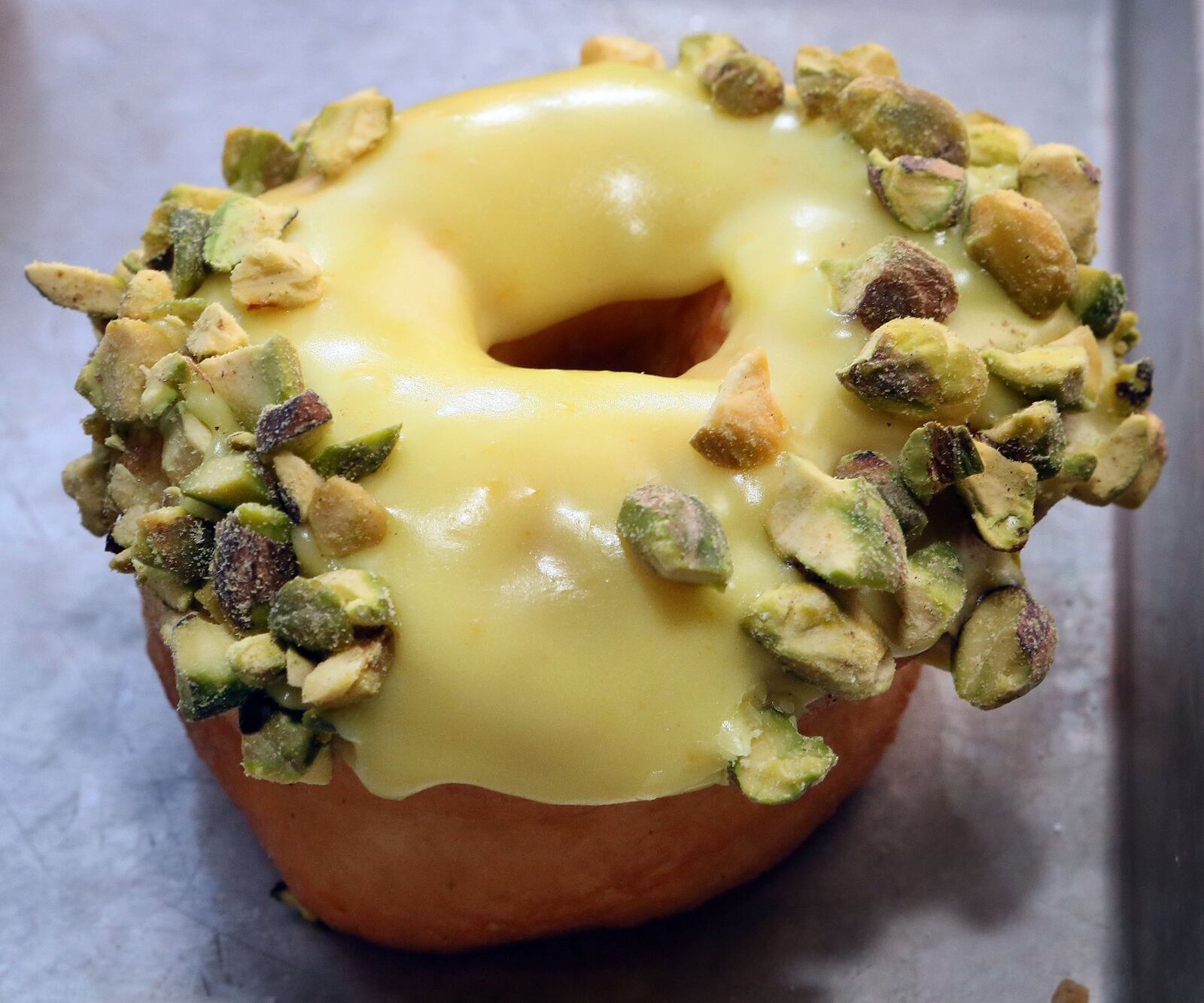 The Orange Pistachio doughnut from Maria Moore Riggs’ Revolution Doughnuts in Decatur is a treat (and it’s vegan). AJC FILE PHOTO 2013