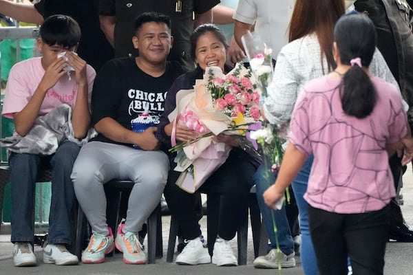 Mary Jane Veloso, center, a Filipino woman who spent almost 15 years in an Indonesian prison for drug trafficking and was nearly executed by firing squad in 2015, is reunited with her family as she arrives at the Correctional Institution for Women in Mandaluyong, Philippines Wednesday, Dec. 18, 2024. (AP Photo/Aaron Favila)