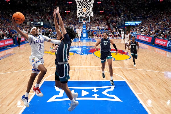 Kansas guard Dajuan Harris Jr. (3) puts up a shot during the first half of an NCAA college basketball game against UNC Wilmington Tuesday, Nov. 19, 2024, in Lawrence, Kan. (AP Photo/Charlie Riedel)