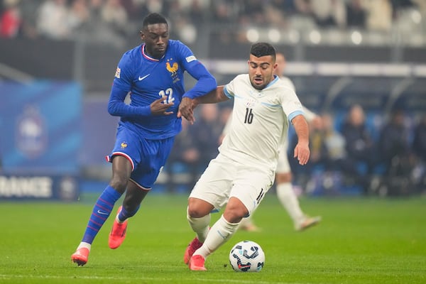 France's Randal Kolo Muani, left, and Israel's Mohammad Abu Fani compete for the ball during the UEFA Nations League soccer match between France and Israel at the Sea de de France stadium in Saint-Denis, outside Paris, Thursday Nov. 14, 2024. (AP Photo/Michel Euler)