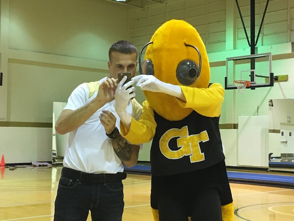 Georgia Tech spirit coordinator Daniel Nester helps a Buzz candidate select the music for a skit at Freshman Gym April 13, 2018. Nester said he was looking for some level of coordination, "but just because a kid is a great dancer doesn’t make them a great mascot. But a kid who can be trained, and we can take them to camps, we can take them to clinics. We can teach them how to be Buzz ." (AJC photo by Ken Sugiura)