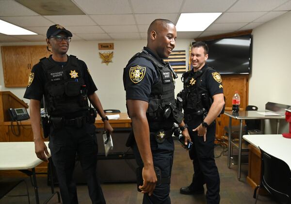 Deputy Warren Hobbs (left) and Deputy Patrick Edmond are greeted by Deputy Kyle Knortz (right) at the Gwinnett County Jail on Thursday, Sept. 10, 2020. In just a matter of weeks, Edmond and Hobbs suffered life-threatening medical emergencies in the Gwinnett County Jail, and inmates came to their aid both times. (Hyosub Shin / Hyosub.Shin@ajc.com)