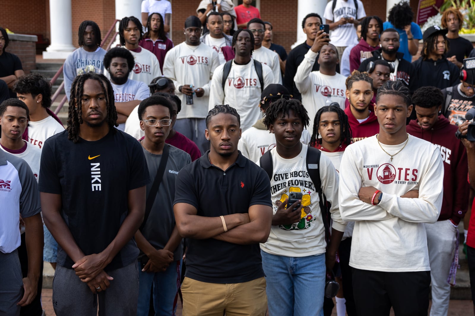 Morehouse College students listen to a speaker Thursday before the March to the Polls from the Morehouse campus to Flipper Temple AME Church in Atlanta. Dozens of students marched to the church to vote early. (Arvin Temkar/AJC)