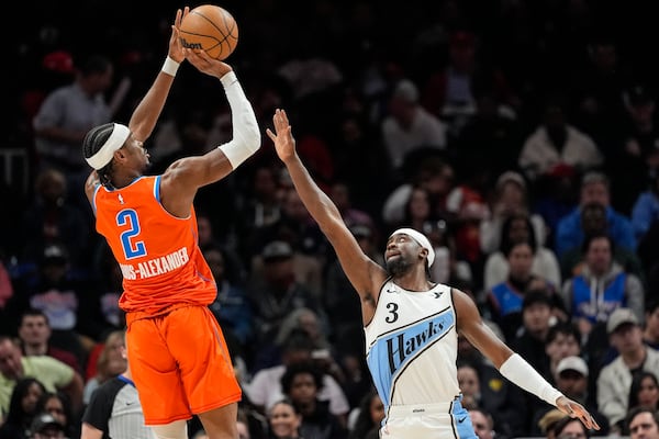 Oklahoma City Thunder guard Shai Gilgeous-Alexander (2) shoots against Atlanta Hawks guard Caris LeVert (3) during the first half of an NBA basketball game, Friday, Feb. 28, 2025, in Atlanta. (AP Photo/Mike Stewart)