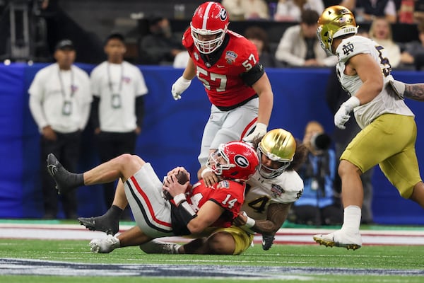 Georgia quarterback Gunner Stockton (14) takes a hit during the first half of the Sugar Bowl.