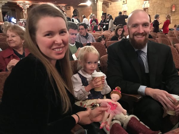 Molly and Lane Pratt and their daughter Ellie wait for the beginning of a performance of “Atlanta Ballet’s Nutcracker” at the Fox Theatre. BO EMERSON / BEMERSON@AJC.COM