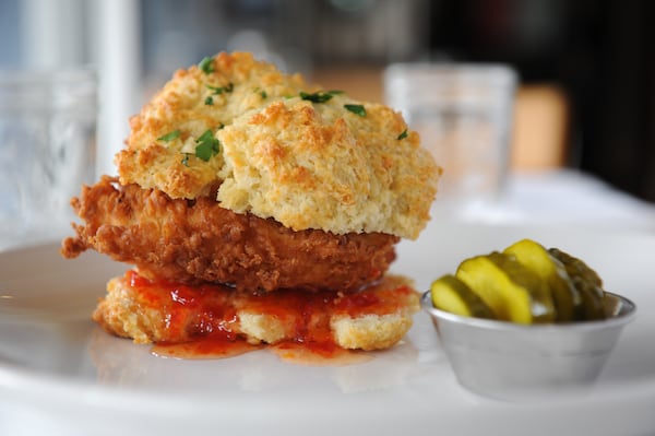 BREAKFAST: Chicken Biscuit- fried chicken breast on a biscuit with house-made red pepper jelly served with pimento cheese grits and house pickles - at Buttermilk Kitchen. (BECKYSTEINPHOTOGRAPHY.COM)